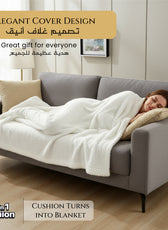 Woman lying on a gray sofa with a white blanket