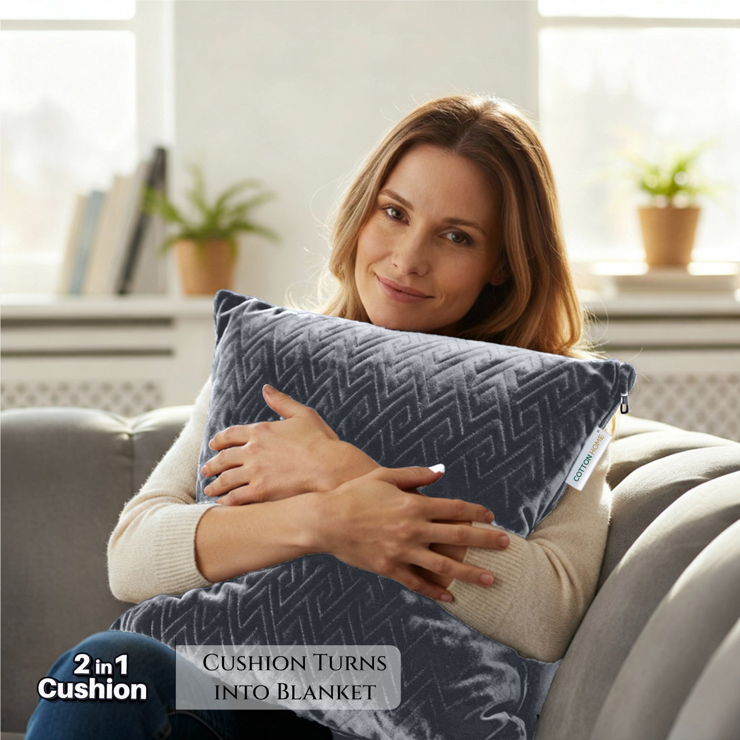 Woman holding a 2-in-1 cushion that turns into a blanket, sitting on a couch
