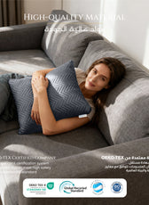 Woman lying on a gray sofa holding a textured pillow by cotton home